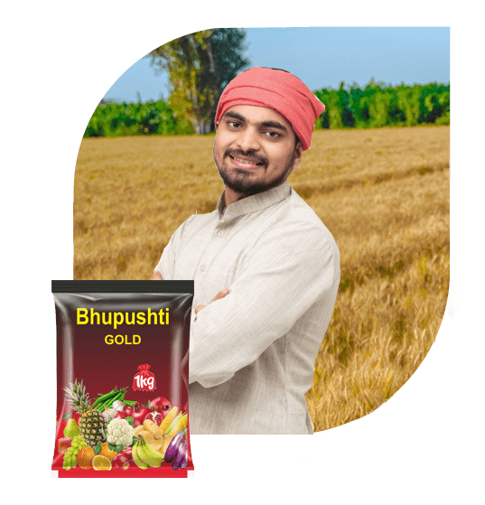 Young farmer in a wheat field with a pack of Bhupushti Gold organic manure