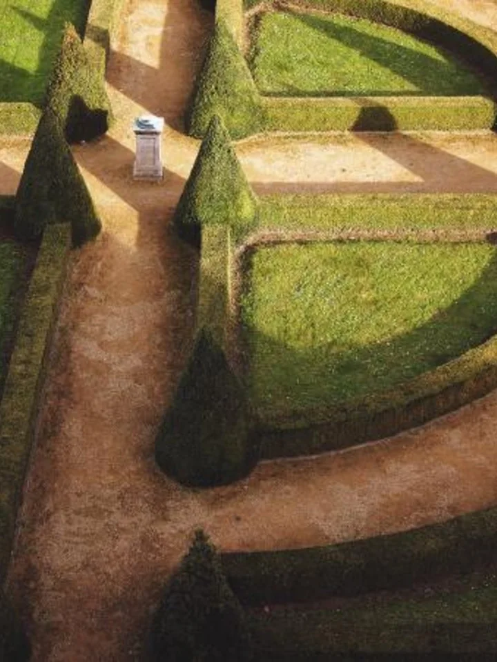 Formal garden with precisely clipped hedges and topiary
